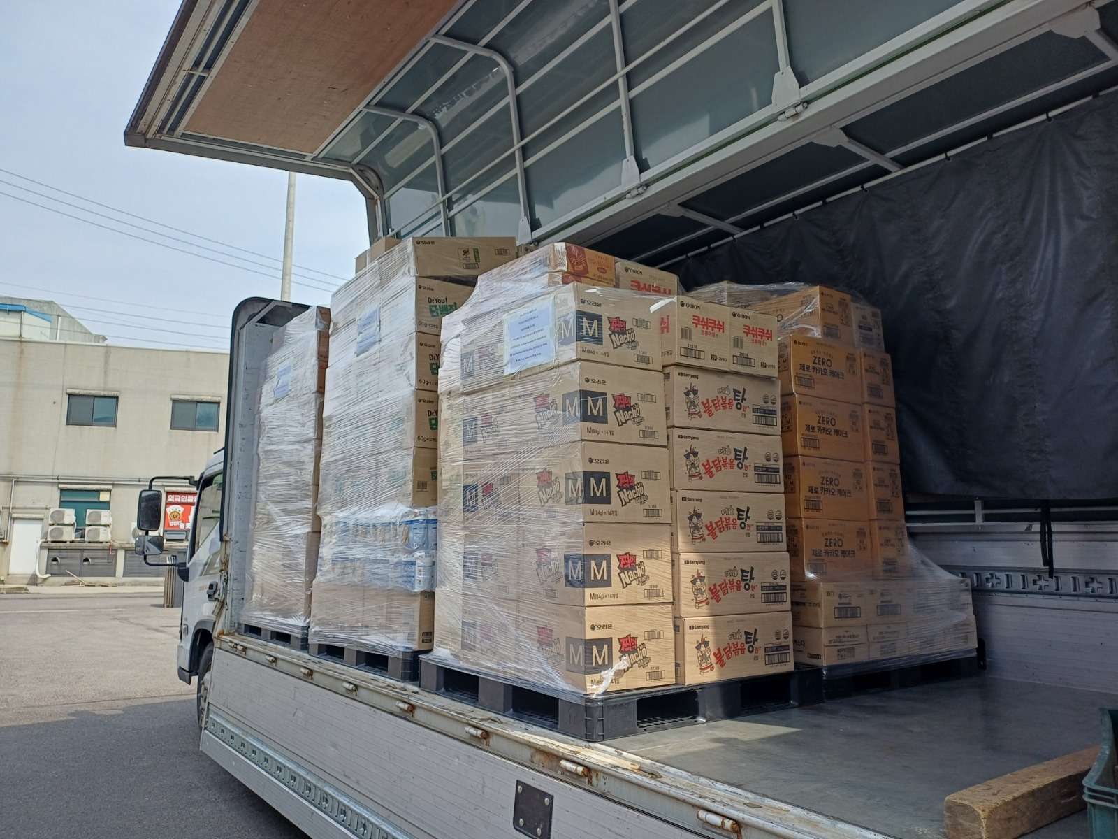 Palletized Korean food cargo being loaded