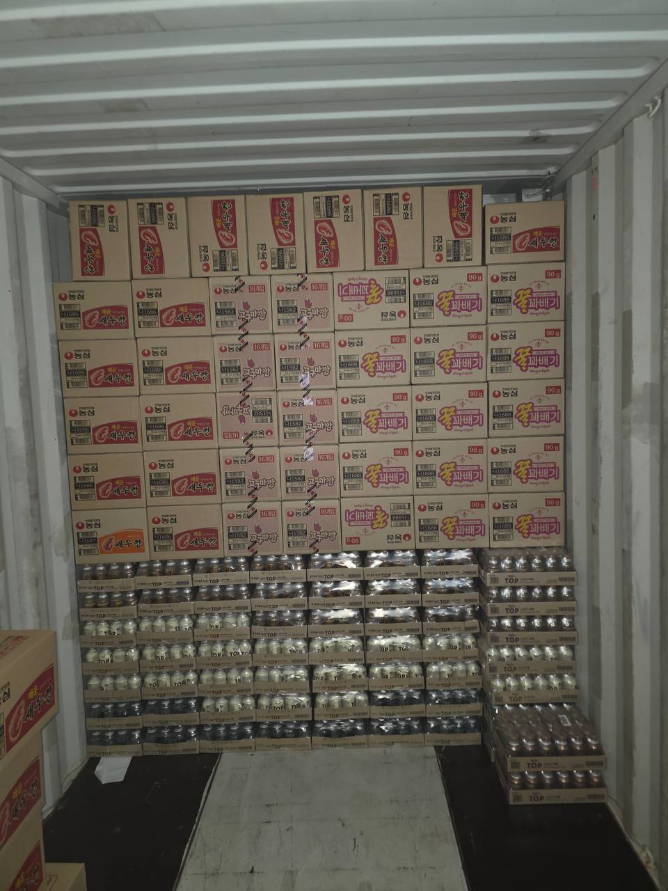 Korean snack and drink cartons stacked for export